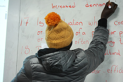 A student writing on a white board