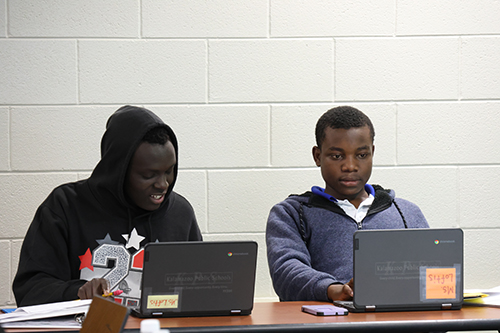 two students using their laptops