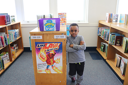 standing next to a book shelf