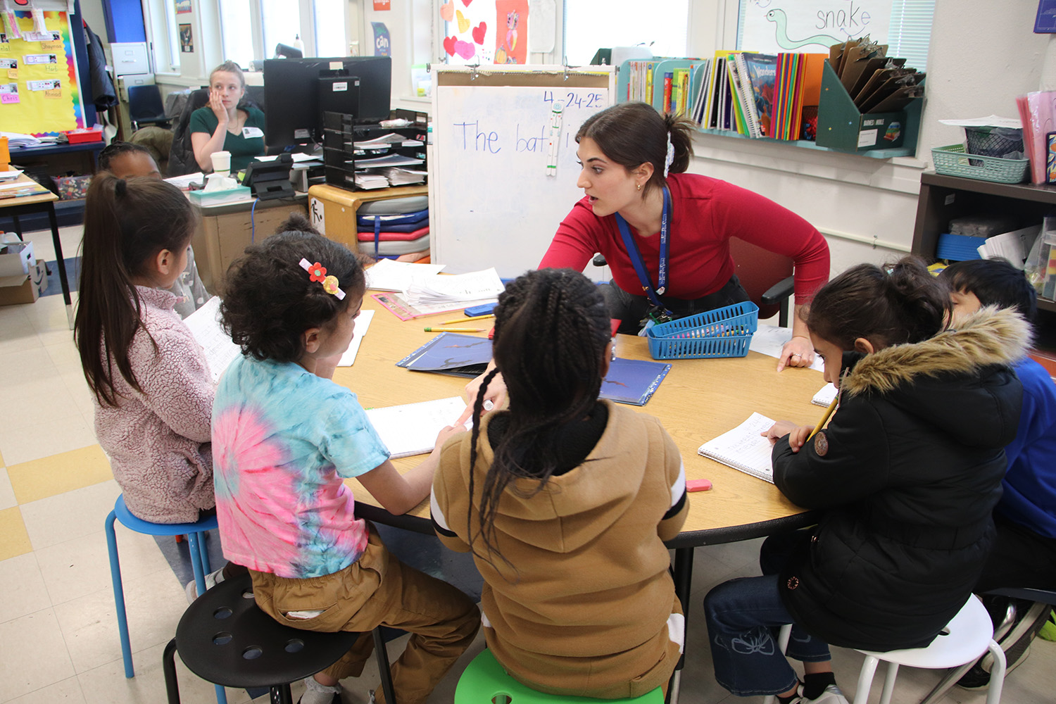 Students and a teacher sitting around a table